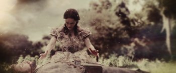 Movie still from “Beautiful Creatures” (2013), directed by Richard LaGravenese – A woman in an old fashioned dress holding a knife; Medium shot, High angle