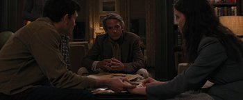Movie still from “Beautiful Creatures” (2013), directed by Richard LaGravenese – A man sitting at a table talking to another man; Medium shot, Over the shoulder angle