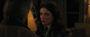 Movie still from “Beautiful Creatures” (2013), directed by Richard LaGravenese – A woman with long dark hair is looking at the camera; Close Up shot, Over the shoulder angle