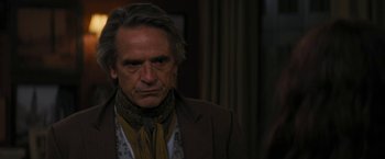 Movie still from “Beautiful Creatures” (2013), directed by Richard LaGravenese – A person wearing a suit and tie; Close Up shot, Over the shoulder angle