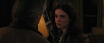 Movie still from “Beautiful Creatures” (2013), directed by Richard LaGravenese – A young woman looking at the camera while a man looks on; Close Up shot, Over the shoulder angle