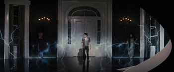 Movie still from “Beautiful Creatures” (2013), directed by Richard LaGravenese – A man standing in front of a door with lightning; Wide shot, Low angle
