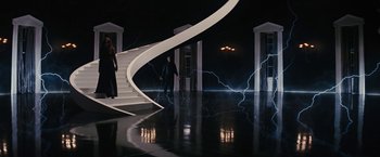 A man and a woman walking down a staircase