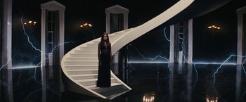 Movie still from “Beautiful Creatures” (2013), directed by Richard LaGravenese – A woman in a black dress standing on a white staircase; Wide shot, High angle