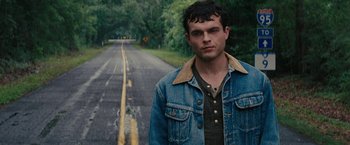 Movie still from “Beautiful Creatures” (2013), directed by Richard LaGravenese – A man standing on the side of a road; Close Up shot, Low angle