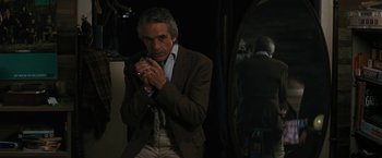 Movie still from “Beautiful Creatures” (2013), directed by Richard LaGravenese – An older man in a brown jacket and white pants; Medium shot, Over the shoulder angle