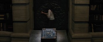 Movie still from “Beautiful Creatures” (2013), directed by Richard LaGravenese – A woman standing in front of an open book; Wide shot, High angle