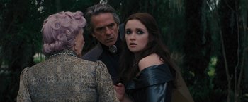 Movie still from “Beautiful Creatures” (2013), directed by Richard LaGravenese – A man and a woman standing next to each other in front of another man; Close Up shot, Over the shoulder angle