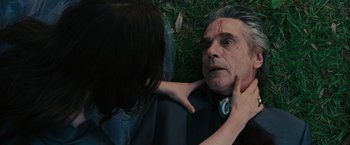 Movie still from “Beautiful Creatures” (2013), directed by Richard LaGravenese – An older man with a cross on his forehead and a young woman touching his face; Close Up shot, Overhead angle