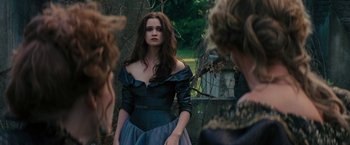 Movie still from “Beautiful Creatures” (2013), directed by Richard LaGravenese – A woman in a black dress standing in front of a tree; Medium shot, Over the shoulder angle