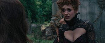 Movie still from “Beautiful Creatures” (2013), directed by Richard LaGravenese – A woman in a black dress is standing in the grass; Close Up shot, Over the shoulder angle