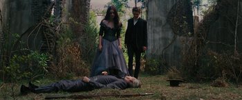 Movie still from “Beautiful Creatures” (2013), directed by Richard LaGravenese – Two men and a woman standing next to a dead body; Wide shot, High angle