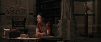 Movie still from “Beautiful Creatures” (2013), directed by Richard LaGravenese – A woman sitting at a table in front of books; Medium shot, High angle