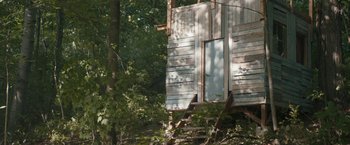 Movie still from “Becky” (2020), directed by Jonathan Milott – A wooden structure in the middle of a forest; Extreme Wide shot, Low angle