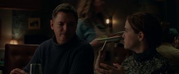 A man and a woman sitting at a dinner table