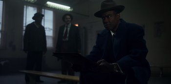 Movie still from “Fargo” (2014), created by Noah Hawley – A man wearing a hat and a jacket; Medium shot, Low angle