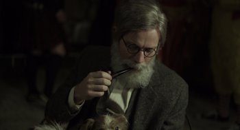 Movie still from “Beginners” (2010), directed by Mike Mills – An old man with a beard and glasses is holding a pipe in his mouth; Close Up shot, High angle