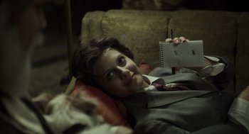 Movie still from “Beginners” (2010), directed by Mike Mills – A woman laying on a couch holding a notepad; Close Up shot, Over the shoulder angle