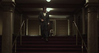 Movie still from “Beginners” (2010), directed by Mike Mills – A man walking down the stairs with a dog; Wide shot, Low angle