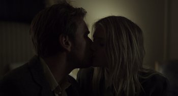 Movie still from “Beginners” (2010), directed by Mike Mills – A man and a woman kissing each other in the dark; Close Up shot, Low angle