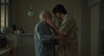 Movie still from “Beginners” (2010), directed by Mike Mills – A man and an old man standing next to each other; Medium shot, Over the shoulder angle