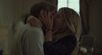 Movie still from “Beginners” (2010), directed by Mike Mills – A man and a woman kissing each other in front of a window; Close Up shot, Low angle