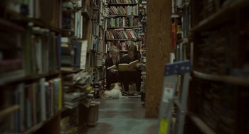 Movie still from “Beginners” (2010), directed by Mike Mills – Two people are reading a book in a book store; Wide shot, High angle