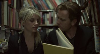 Movie still from “Beginners” (2010), directed by Mike Mills – A man and a woman looking at a book in a library; Close Up shot, Over the shoulder angle