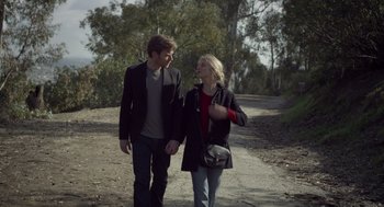Movie still from “Beginners” (2010), directed by Mike Mills – A man and a woman walking down a dirt road; Medium shot, High angle