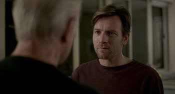 Movie still from “Beginners” (2010), directed by Mike Mills – A man looking into a mirror while standing next to another man; Close Up shot, Over the shoulder angle