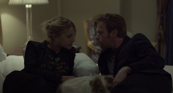 Movie still from “Beginners” (2010), directed by Mike Mills – A man and a woman sitting next to each other on a bed; Medium shot, Over the shoulder angle