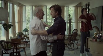 Movie still from “Beginners” (2010), directed by Mike Mills – Two men are dancing in a living room together; Medium shot, Over the shoulder angle