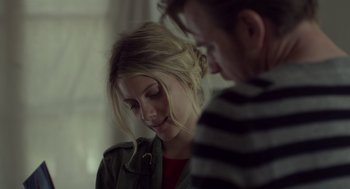 Movie still from “Beginners” (2010), directed by Mike Mills – A man and a woman looking at something on a table; Close Up shot, Over the shoulder angle