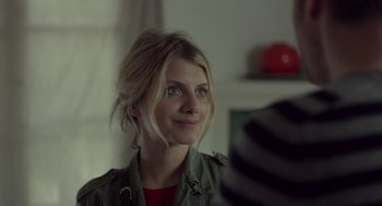 Movie still from “Beginners” (2010), directed by Mike Mills – A beautiful blonde woman looking into a mirror; Close Up shot, Over the shoulder angle