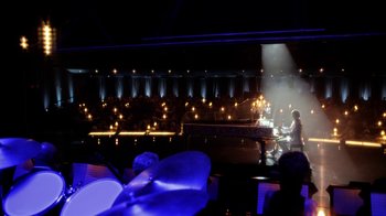 Movie still from “Behind the Candelabra” (2013), directed by Steven Soderbergh – A man playing piano in front of an audience in a dark room; Extreme Wide shot, High angle