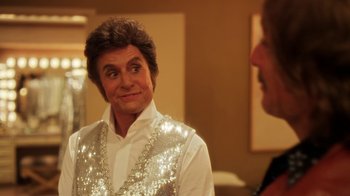 Movie still from “Behind the Candelabra” (2013), directed by Steven Soderbergh – A man in a sequined shirt is looking at another man; Close Up shot, Over the shoulder angle