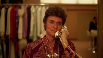 Movie still from “Behind the Candelabra” (2013), directed by Steven Soderbergh – An older woman talking on a phone in a room; Close Up shot, High angle