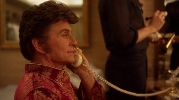 Movie still from “Behind the Candelabra” (2013), directed by Steven Soderbergh – An older woman talking on a phone while sitting down; Close Up shot, Low angle