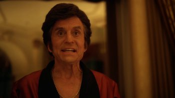 Movie still from “Behind the Candelabra” (2013), directed by Steven Soderbergh – An older man wearing a black shirt and a red jacket; Close Up shot, Low angle