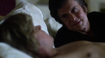 Movie still from “Behind the Candelabra” (2013), directed by Steven Soderbergh – An older woman is looking at a pillow; Close Up shot, Over the shoulder angle