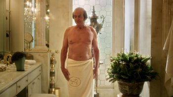 Movie still from “Behind the Candelabra” (2013), directed by Steven Soderbergh – An old man is standing in a bathroom with a towel around his waist; Medium shot, Over the shoulder angle