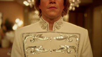 Movie still from “Behind the Candelabra” (2013), directed by Steven Soderbergh – A person wearing a white suit; Close Up shot, Low angle