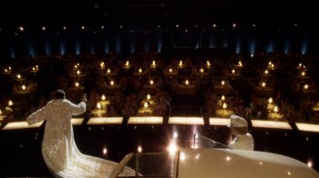 Movie still from “Behind the Candelabra” (2013), directed by Steven Soderbergh – A stage lit up at night with lights on; Extreme Wide shot, High angle