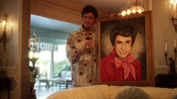 Movie still from “Behind the Candelabra” (2013), directed by Steven Soderbergh – A man standing in front of a painting of himself; Medium shot, Over the shoulder angle