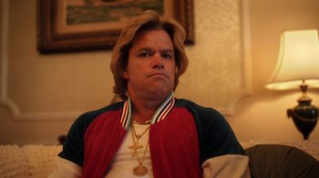 Movie still from “Behind the Candelabra” (2013), directed by Steven Soderbergh – A man wearing a red jacket with a gold cross on it; Close Up shot, Low angle
