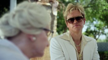 Movie still from “Behind the Candelabra” (2013), directed by Steven Soderbergh – A man in a white jacket and a woman in a white jacket; Close Up shot, Low angle