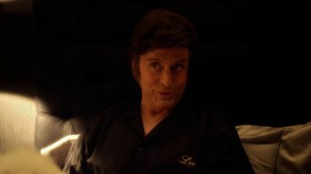 Movie still from “Behind the Candelabra” (2013), directed by Steven Soderbergh – A man in a black shirt is looking at the camera; Close Up shot, Over the shoulder angle