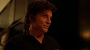Movie still from “Behind the Candelabra” (2013), directed by Steven Soderbergh – A person wearing a black shirt; Close Up shot, Over the shoulder angle