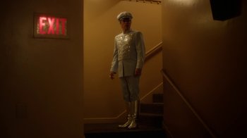 Movie still from “Behind the Candelabra” (2013), directed by Steven Soderbergh – A man dressed in a white suit and hat; Wide shot, Low angle