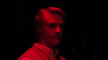 Movie still from “Behind the Candelabra” (2013), directed by Steven Soderbergh – A man with a beard and a mustache in the dark; Close Up shot, Low angle